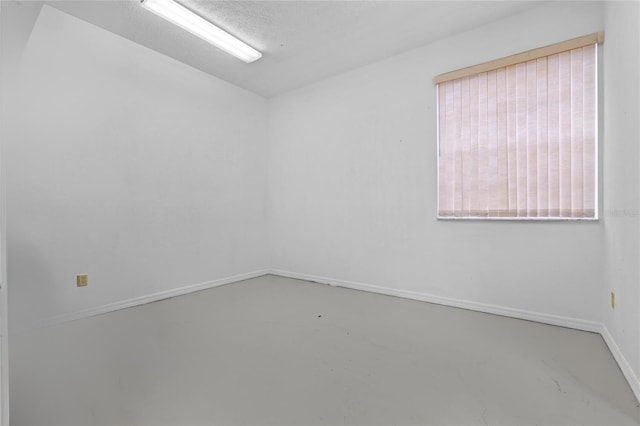 spare room with concrete floors