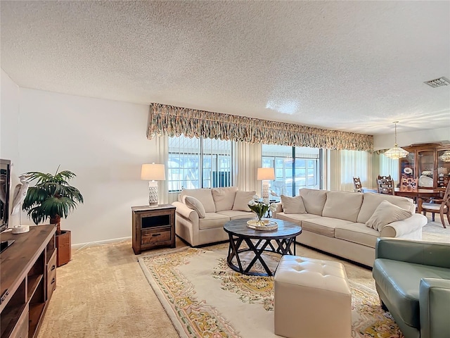 living room featuring a textured ceiling and light colored carpet