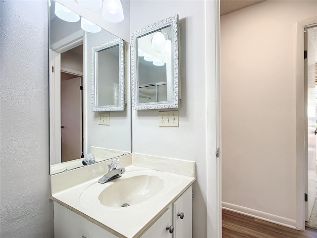 bathroom featuring vanity and hardwood / wood-style flooring