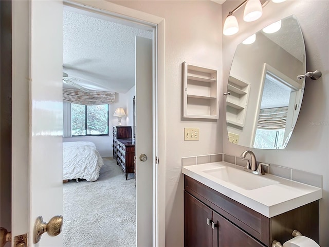 bathroom featuring a textured ceiling and vanity