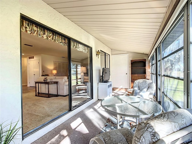 sunroom featuring vaulted ceiling