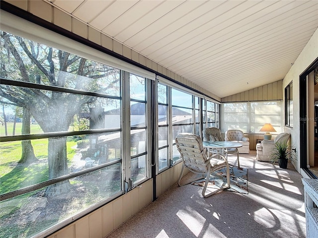 sunroom with plenty of natural light and vaulted ceiling