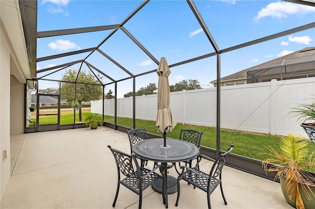 view of patio featuring glass enclosure