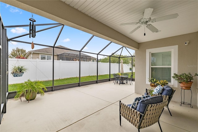 view of patio / terrace featuring glass enclosure and ceiling fan