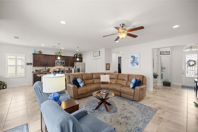 living room with ceiling fan and light tile patterned floors