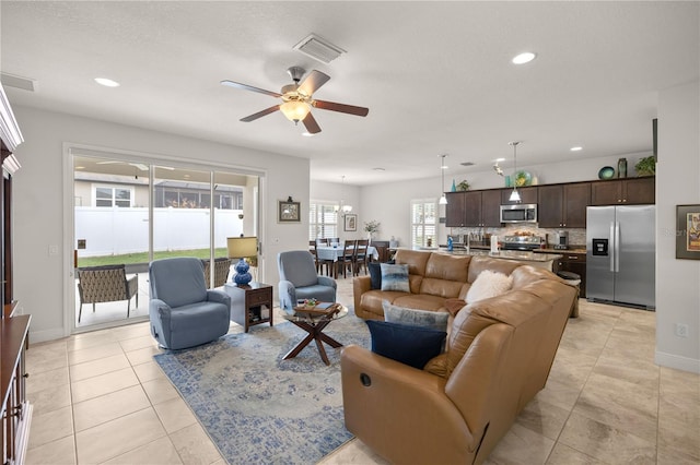 living room featuring ceiling fan and light tile patterned floors