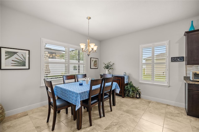 dining area with light tile patterned flooring and a chandelier