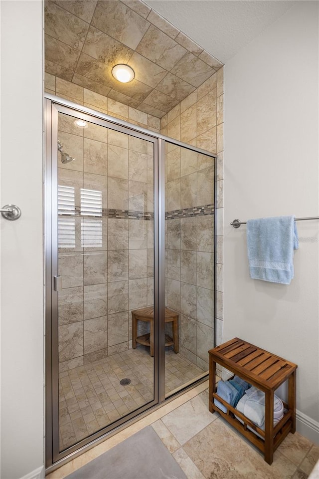 bathroom featuring a shower with door