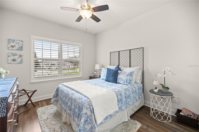 bedroom with ceiling fan and dark wood-type flooring