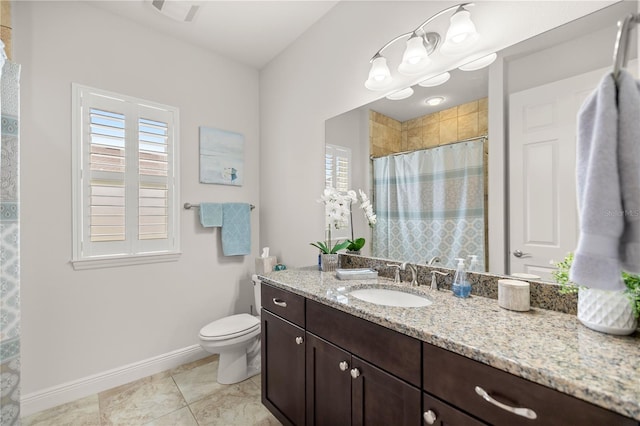 bathroom featuring tile patterned flooring, vanity, a shower with shower curtain, and toilet