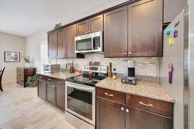 6407 SW 45th Ave, Ocala, FL 34474 - kitchen featuring stainless steel appliances, tasteful backsplash, dark brown cabinetry, and light stone countertops