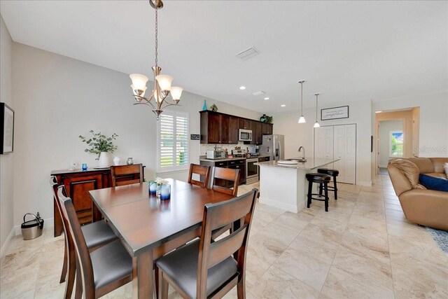 6407 SW 45th Ave, Ocala, FL 34474 - dining space with a chandelier and baseboards