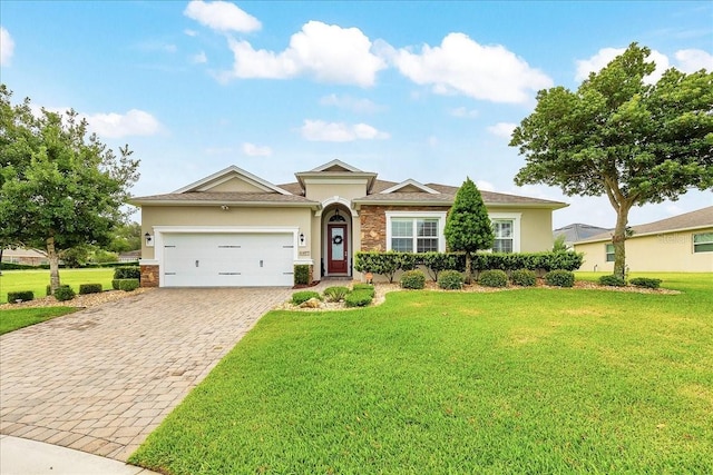 6407 SW 45th Ave, Ocala, FL 34474 - view of front of home with stucco siding, stone siding, decorative driveway, an attached garage, and a front yard