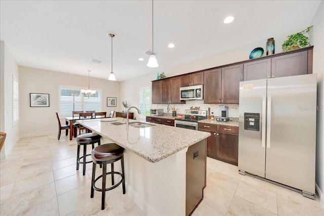 6407 SW 45th Ave, Ocala, FL 34474 - kitchen featuring stainless steel appliances, a sink, an island with sink, dark brown cabinetry, and recessed lighting