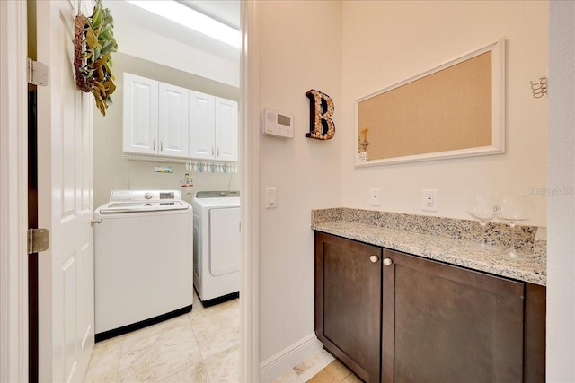 6407 SW 45th Ave, Ocala, FL 34474 - laundry room with separate washer and dryer, light tile patterned floors, cabinet space, and baseboards