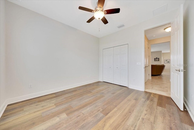 6407 SW 45th Ave, Ocala, FL 34474 - unfurnished bedroom with light wood finished floors, a closet, baseboards, and ceiling fan