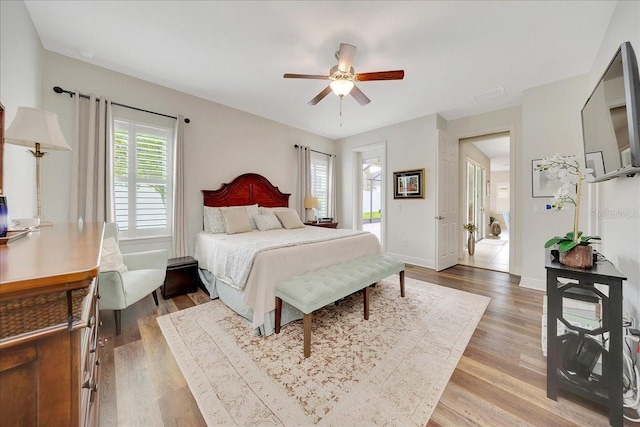 6407 SW 45th Ave, Ocala, FL 34474 - bedroom featuring light wood-style floors, ceiling fan, baseboards, and access to outside