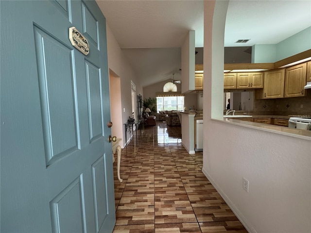 hallway with lofted ceiling