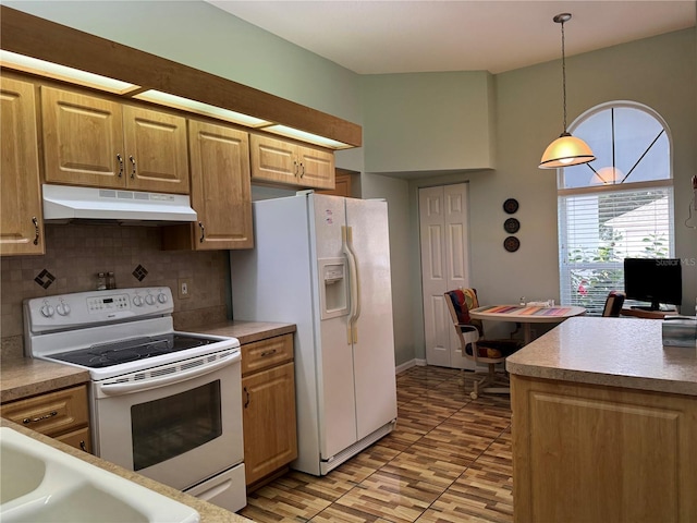 kitchen featuring pendant lighting, white appliances, and tasteful backsplash