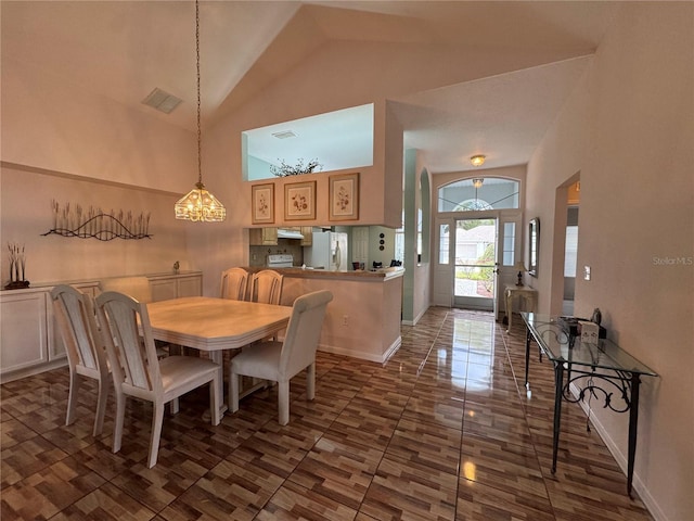 dining room featuring high vaulted ceiling