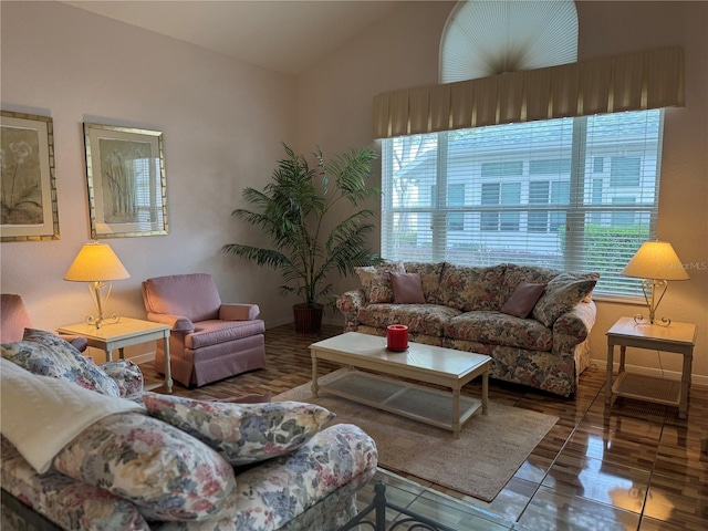 living room with tile patterned flooring, a healthy amount of sunlight, and vaulted ceiling