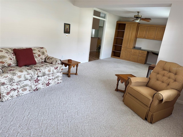 living room with light colored carpet and ceiling fan