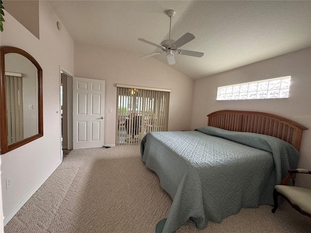 carpeted bedroom with ceiling fan and vaulted ceiling