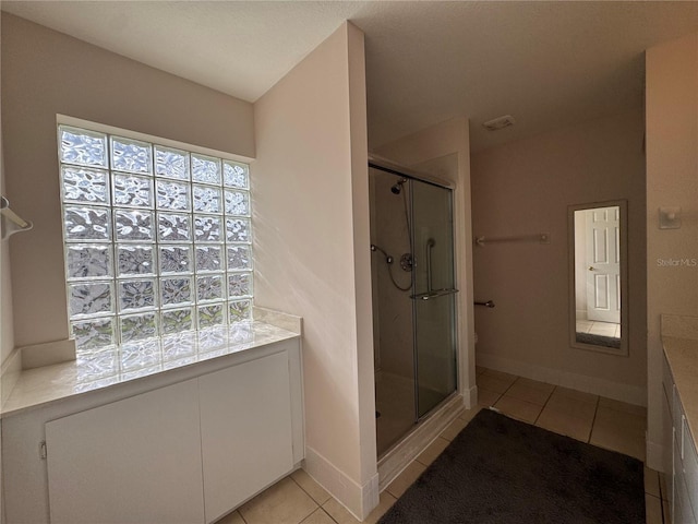 bathroom featuring vanity, tile patterned floors, and an enclosed shower