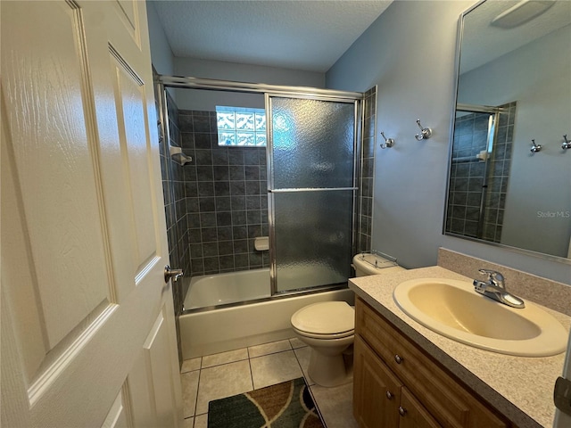 full bathroom featuring toilet, vanity, tile patterned floors, and enclosed tub / shower combo