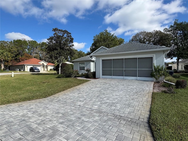 single story home with a garage and a front lawn