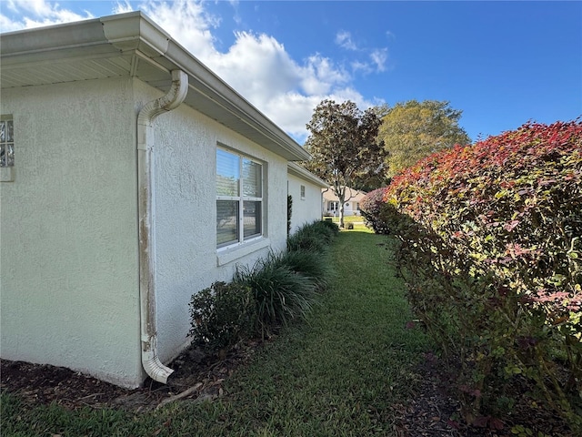 view of side of home featuring a yard