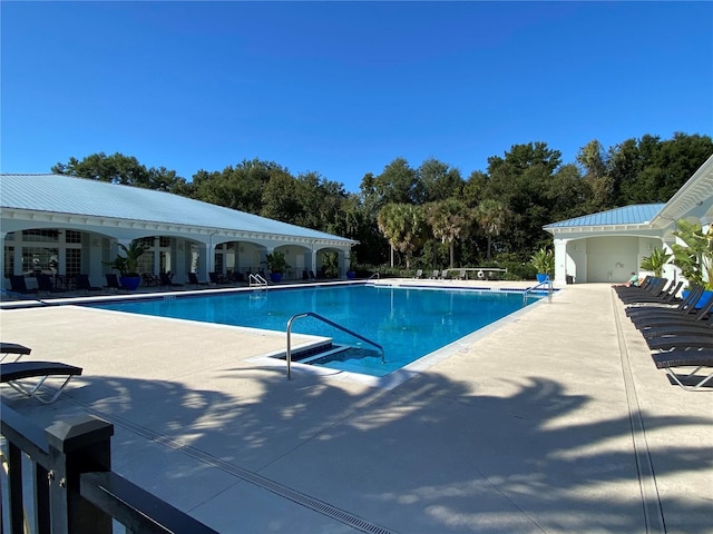 view of swimming pool with a patio