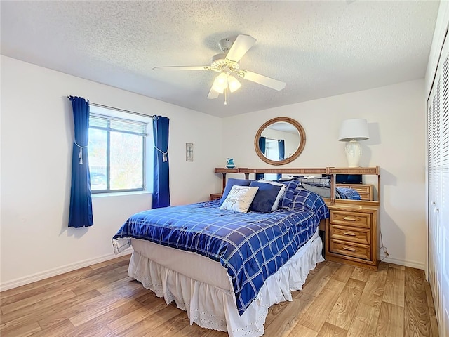 bedroom featuring ceiling fan, a closet, a textured ceiling, and hardwood / wood-style flooring