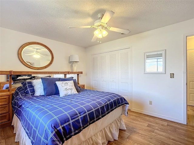 bedroom with ceiling fan, a closet, a textured ceiling, and hardwood / wood-style flooring