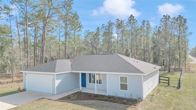 ranch-style house with covered porch, a front yard, and a garage