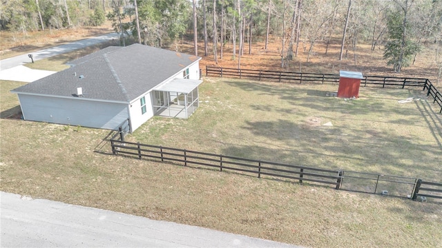 birds eye view of property with a rural view