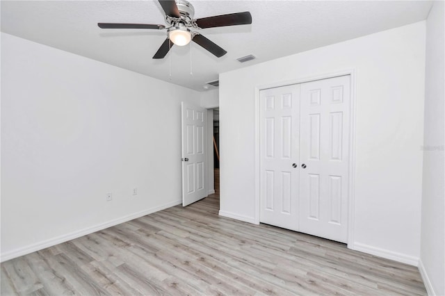 unfurnished bedroom with a closet, ceiling fan, and light hardwood / wood-style floors