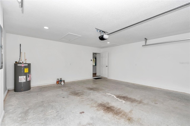 garage featuring water heater and a garage door opener