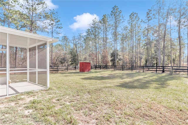 view of yard featuring a storage unit and a sunroom