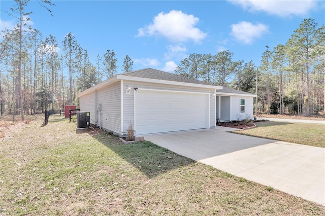 exterior space with a garage, a yard, and central AC