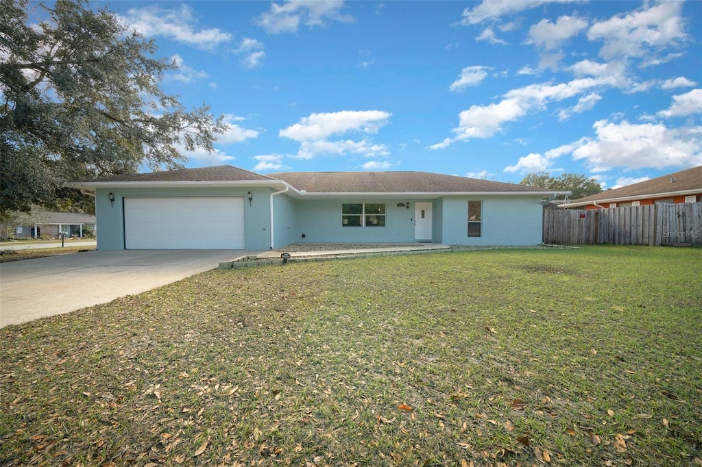 ranch-style house featuring a front lawn and a garage