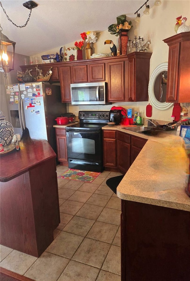 kitchen featuring light tile patterned flooring, sink, and appliances with stainless steel finishes