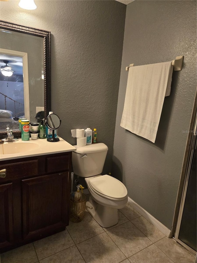 bathroom featuring tile patterned flooring, vanity, and toilet