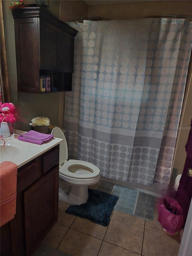 bathroom featuring tile patterned flooring, vanity, and toilet