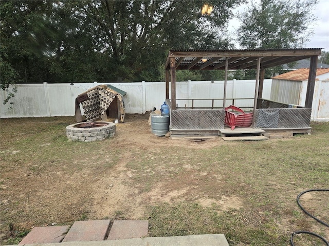 view of yard with a pergola and a fire pit