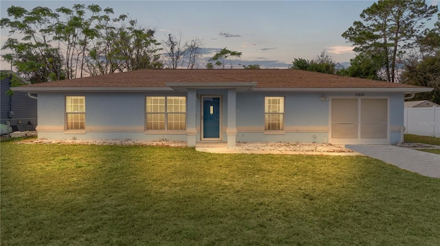 ranch-style house featuring a yard