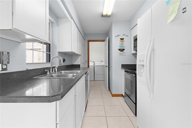 kitchen featuring white cabinetry, sink, white fridge with ice dispenser, washer and dryer, and range