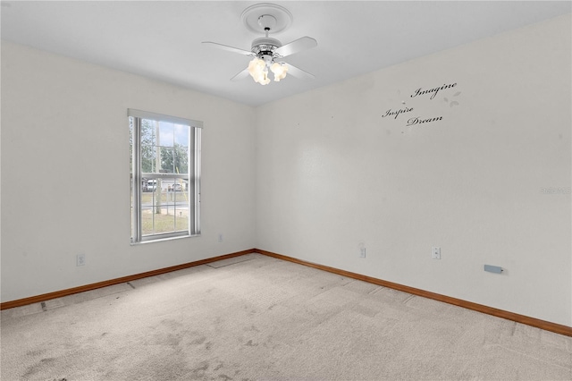 carpeted empty room with ceiling fan