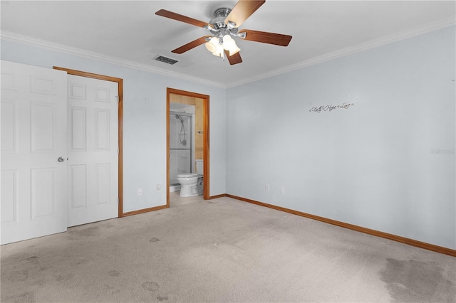 unfurnished bedroom featuring ensuite bathroom, ornamental molding, light colored carpet, ceiling fan, and a closet