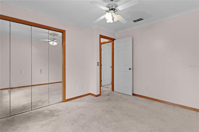 unfurnished bedroom featuring light carpet, a closet, ceiling fan, and ornamental molding